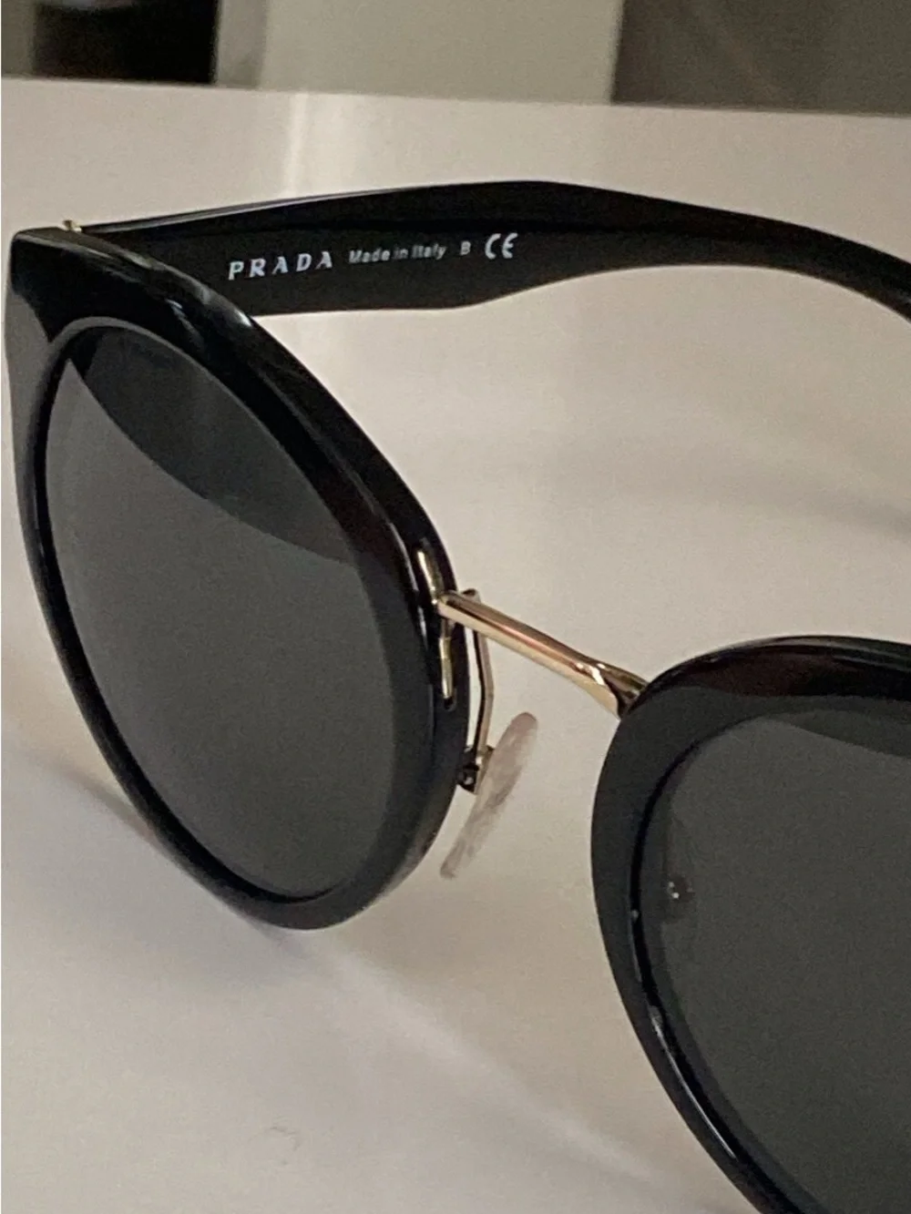 Prada Black Round Sunglasses with Gold Detailing
